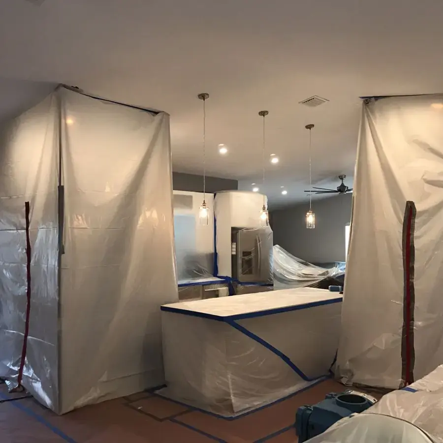 Containment sheeting set up in a kitchen during a Miami Beach water damage job