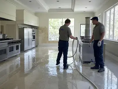 Extraction hoses clearing water off a marble floor in a Miami Beach home