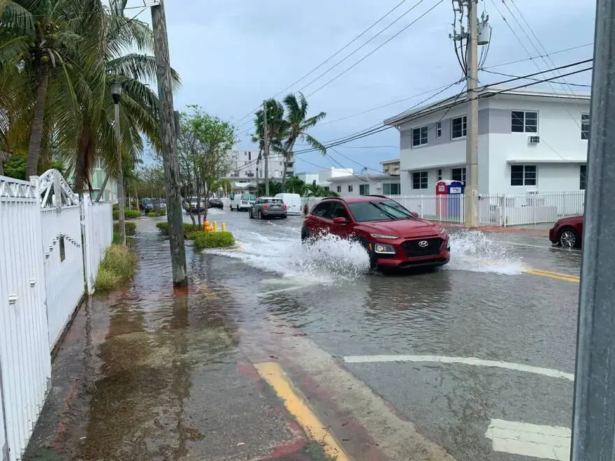Street flooding outside low-rise buildings during a high tide near Miami Beach