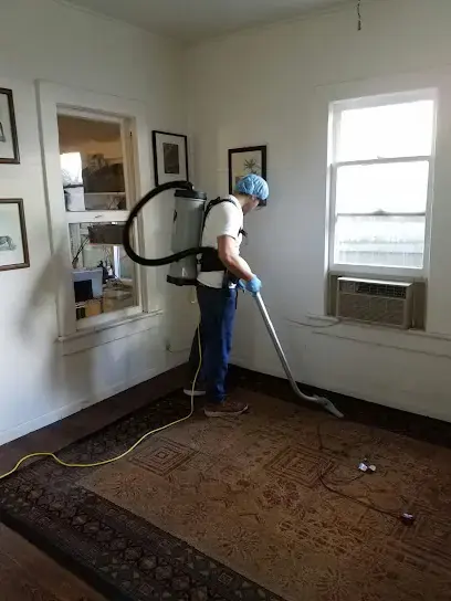 Backpack vacuum cleanup of a wet rug during a Miami Beach water damage dry-out