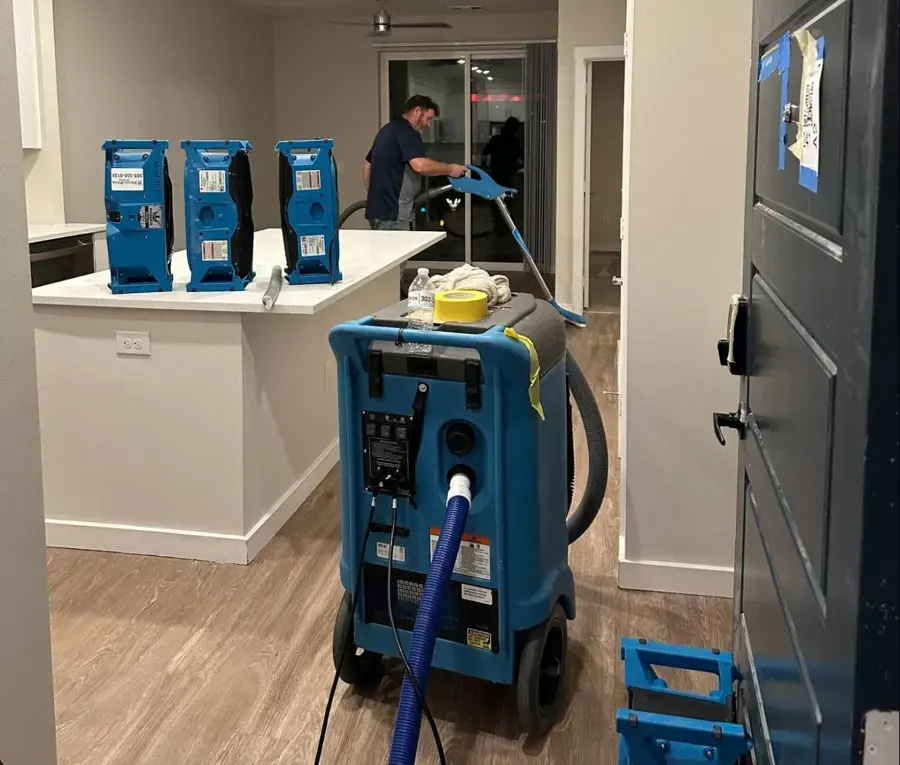 Dehumidifiers and extraction gear set up in a Miami Beach condo kitchen
