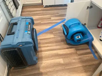 Dehumidifier and air mover drying a vinyl plank floor in Miami Beach