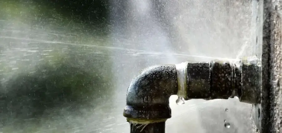 Water spraying from a failed pipe fitting during a Miami Beach burst pipe loss