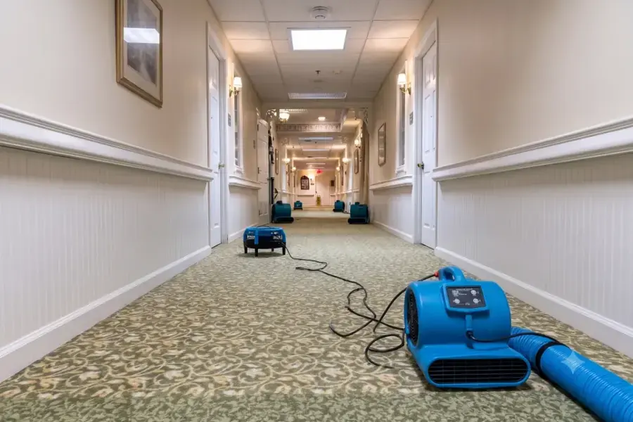 Air mover drying the carpet of a hotel corridor in Miami Beach