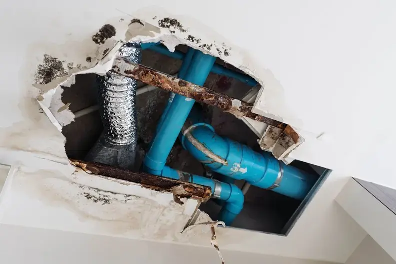 Ceiling opened to reach the pipes after a leak from the condo unit above in Miami Beach