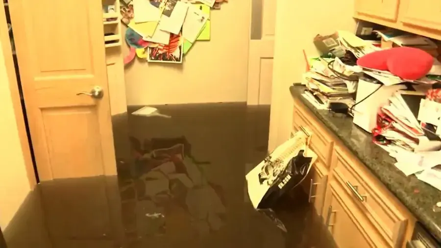 Flood water and floating debris inside a Miami Beach home after a storm surge
