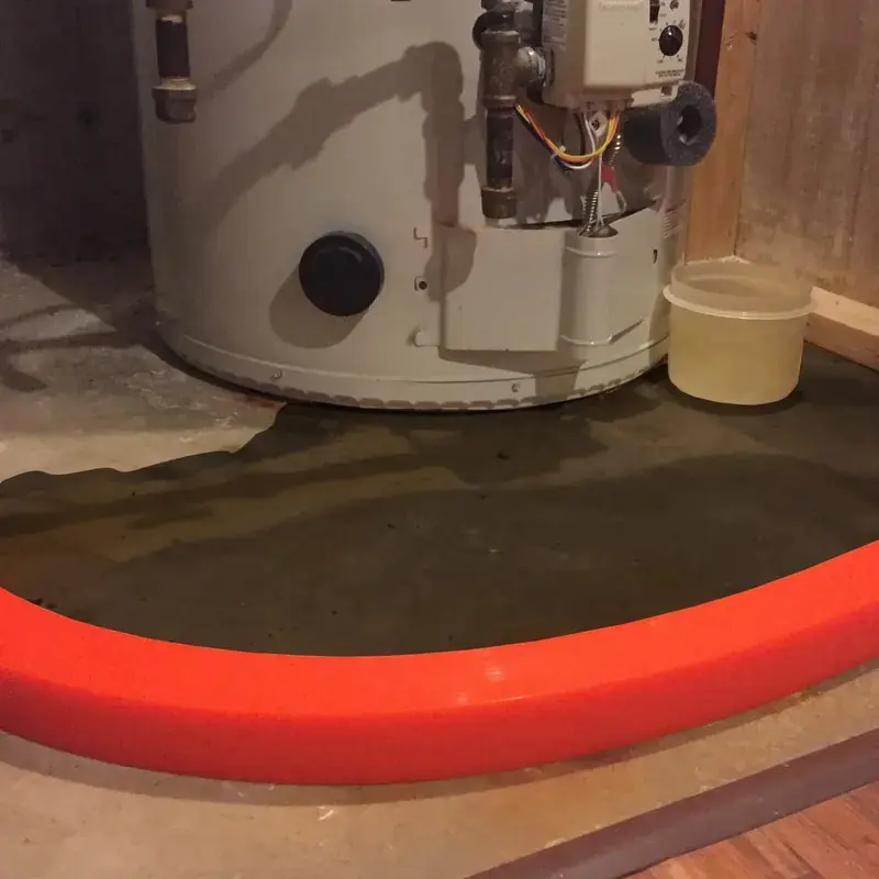 Water collecting around a leaking water heater in a Miami Beach utility closet